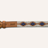 The Cowboy by Zilker Belts is a hand-stitched belt made from premium Argentine leather, with a brass buckle, blue and brown geometric pattern, and "ZILKER" stamped near the buckle.