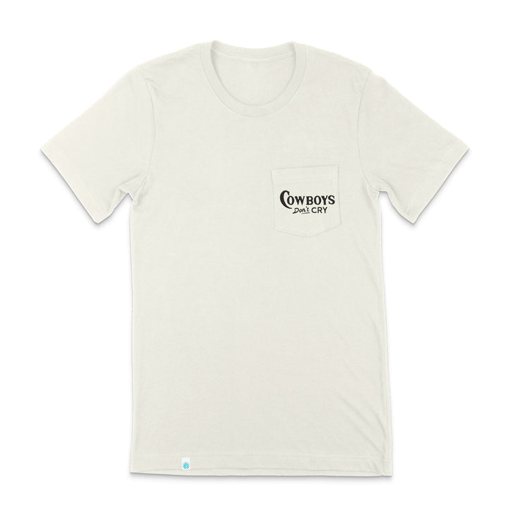 The Cowboys Don't Cry Pocket T-Shirt by Sendero Provisions Co. is a plain white organic cotton tee with a chest pocket featuring black "COWBOYS DON'T CRY" text and a soft touch screen print.