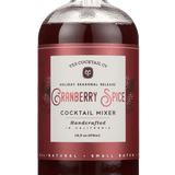 A 16 fl oz (473 ml) glass bottle of red liquid labeled "Cranberry Spice" by Yes Cocktail Co., featuring holiday cocktail mixer seasonal release branding.