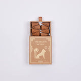 An open box labeled "Dream Lion Incense" reveals eight brown incense cones—Creative Imagination Sandalwood & Rose Petals Incense—blending soothing sandalwood and rose petals by Dream Lion Incense.