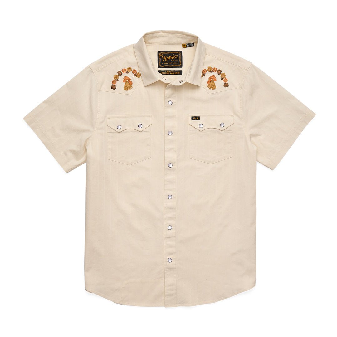 The Howler Brothers Crosscut Deluxe Snapshirt | Fowl Play is a short-sleeve, beige pearl snap shirt featuring front pockets and custom floral embroidery on the shoulders.