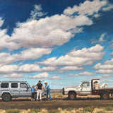 Two vehicles pause on a rural road as people gather nearby, while a child and dog stand near the truck—captured in "Cultural Exchange" by Matt Tumlinson, available as a fine art print on matte cotton paper.