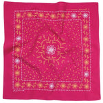 The “Heritage Cotton Bandana - ‘for Goodness Sake’” by Jenni Earle features a bold red cotton fabric adorned with intricate, symmetrical yellow and white floral and vine patterns—perfect for styling as a western neckerchief or giving as an uplifting encouragement gift.