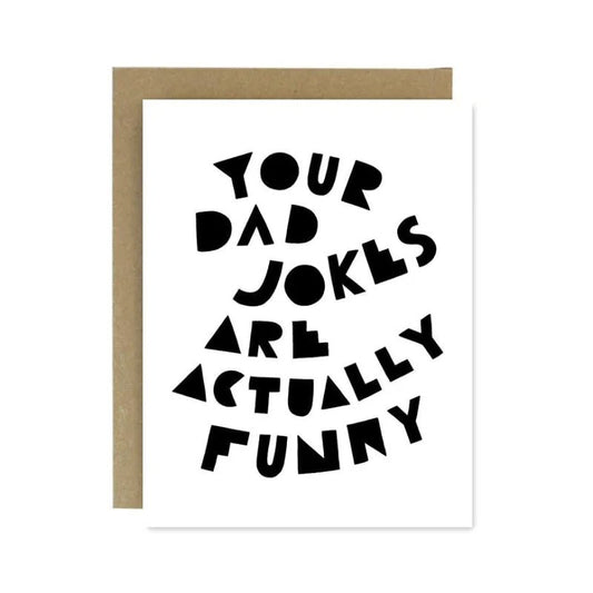 The Dad Jokes Father's Day Card by Worthwhile Paper features bold, quirky black text: "Your dad jokes are actually funny." With a blank inside and envelope, it's a perfect humorous card for any occasion.