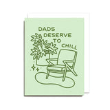 The Dads Deserve to Chill Card by Worthwhile Paper features a chair, plant, and "Dads deserve to chill" text on light green. Printed on recycled paper and blank inside for your own message.