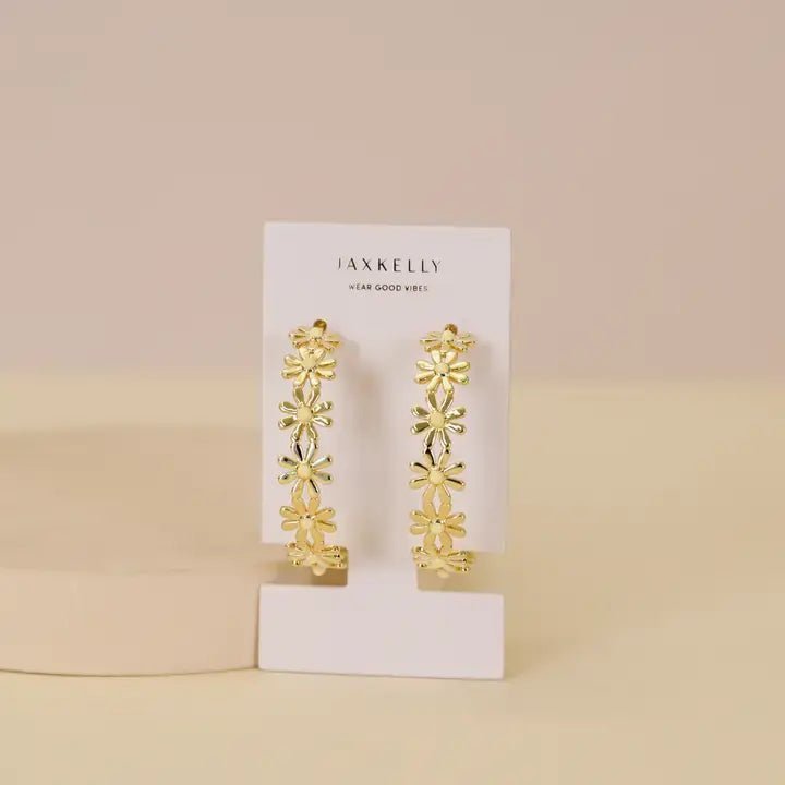 A pair of JaxKelly Daisy Chain Hoop Earrings, tarnish-free jewelry, shown on a white JaxKelly card against a neutral background.