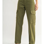 A person in JBD's Dark Olive Cargo high-waisted, wide-leg pants with side pockets, styled with open-toed heeled sandals and a cropped top.
