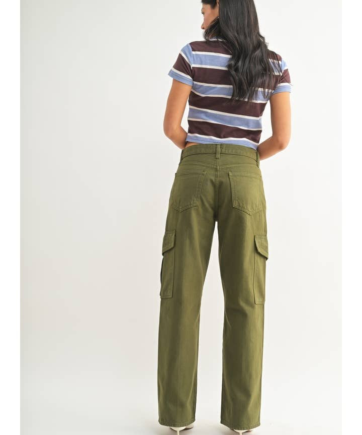A person stands facing away, wearing a short-sleeve striped shirt and the JBD Dark Olive Cargo pants, which are high-rise, wide-leg with side pockets, against a plain white background.