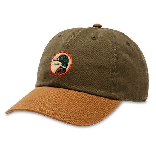 The Duck Head Dark Olive Circle Patch Twill Hat features a brown brim and a signature circular duck head patch, making it a standout accessory for everyday style.