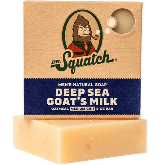A partially unwrapped 5 oz bar of Dr.Squatch Deep Sea Goat's Milk Soap for men in oatmeal medium grit shows its light beige color—a natural goat milk moisturizer that rejuvenates as it cleanses.