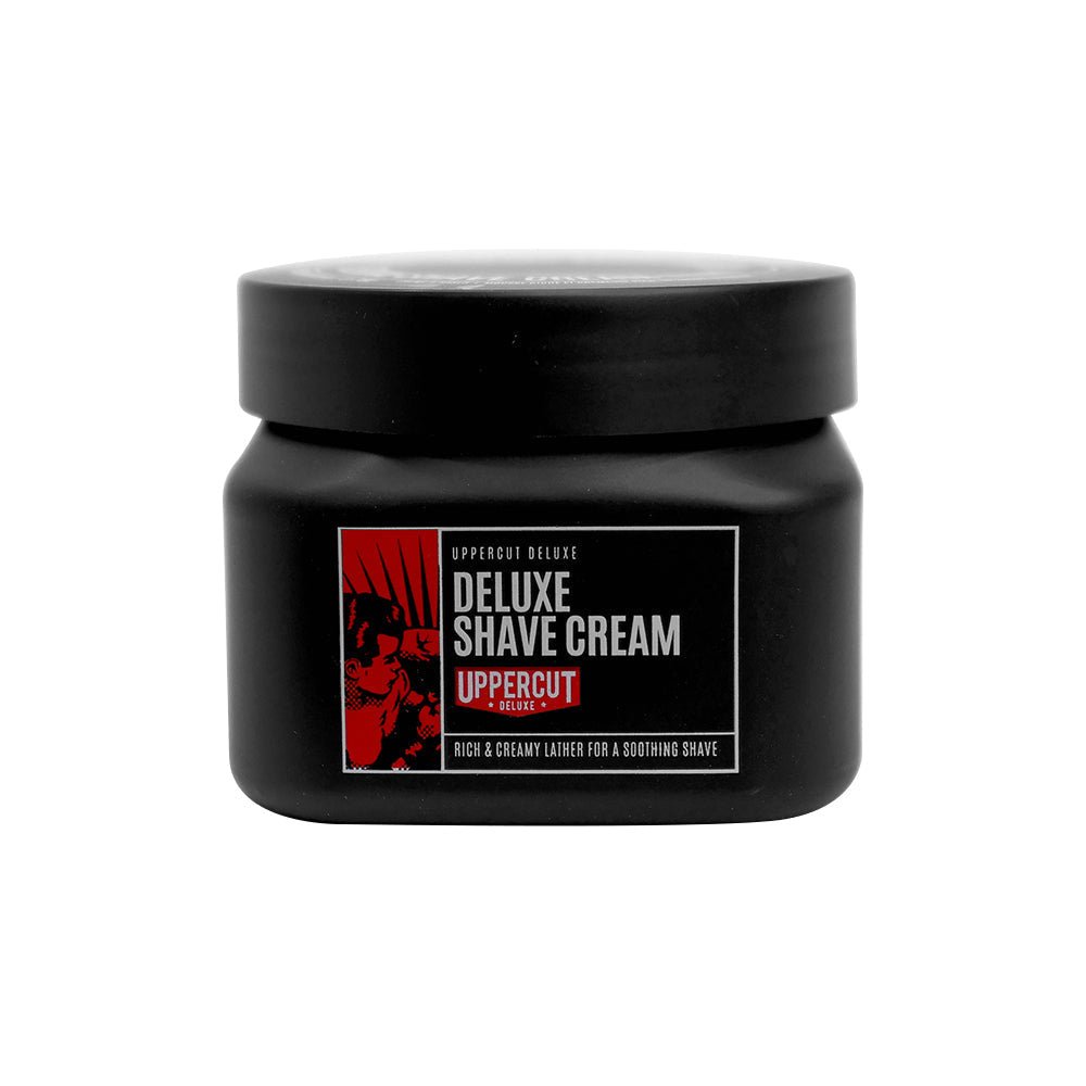 A black jar of Uppercut Deluxe Deluxe Shave Cream with a red and white label, designed for a rich lather that helps prevent razor burn and is suitable for sensitive skin.
