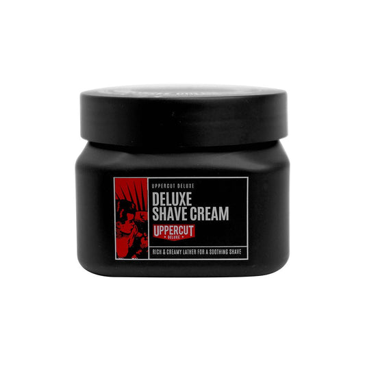 A black jar of Uppercut Deluxe Deluxe Shave Cream with a red and white label, designed for a rich lather that helps prevent razor burn and is suitable for sensitive skin.
