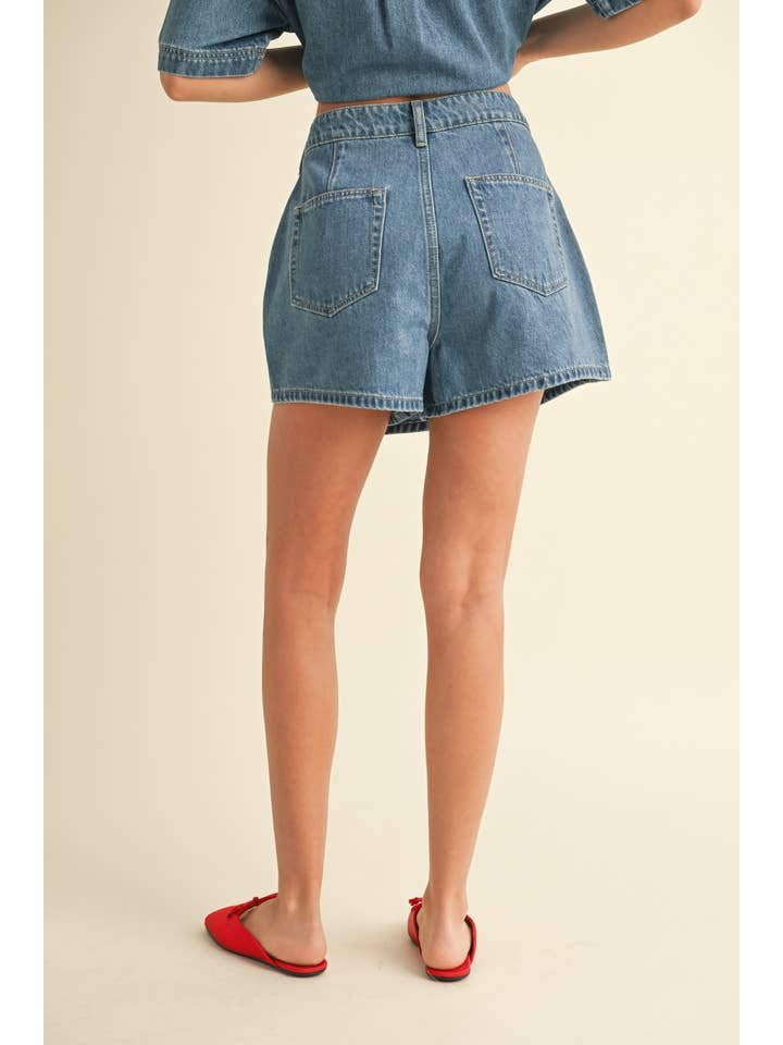 A person is shown from the back against a plain background, wearing a matching top and the Miou Muse Denim Skort with red flats—an effortless women's fashion look.