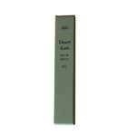 A rectangular box labeled "Desert Kush Eau De Parfum | dilo" stands upright against a white background, highlighting this distinctive dlo fragrance.