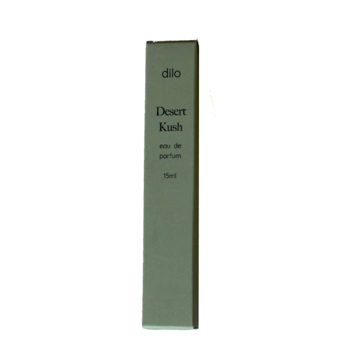 A rectangular box labeled "Desert Kush Eau De Parfum | dilo" stands upright against a white background, highlighting this unique fragrance from the brand dilo.
