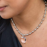 Close-up of a person wearing the Die Heart Necklace by Peter and June, featuring an adjustable beaded chain and a heart-shaped pendant crafted from waterproof stainless steel.