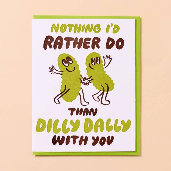 The Dilly Dally Pickle Birthday Card by And Here We Are features hand-printed cartoon pickles holding hands with the message, "Nothing I'd rather do than dilly dally with you.