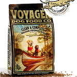 A bag of Voyager Dog Food Co. Dog Food featuring an illustration of three dogs in a canoe, kibble scattered around the packaging, and the Voyager Dog Food Co. logo above.