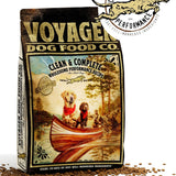 A bag of Voyager Dog Food Co. Dog Food featuring an illustration of three dogs in a canoe, kibble scattered around the packaging, and the Voyager Dog Food Co. logo above.