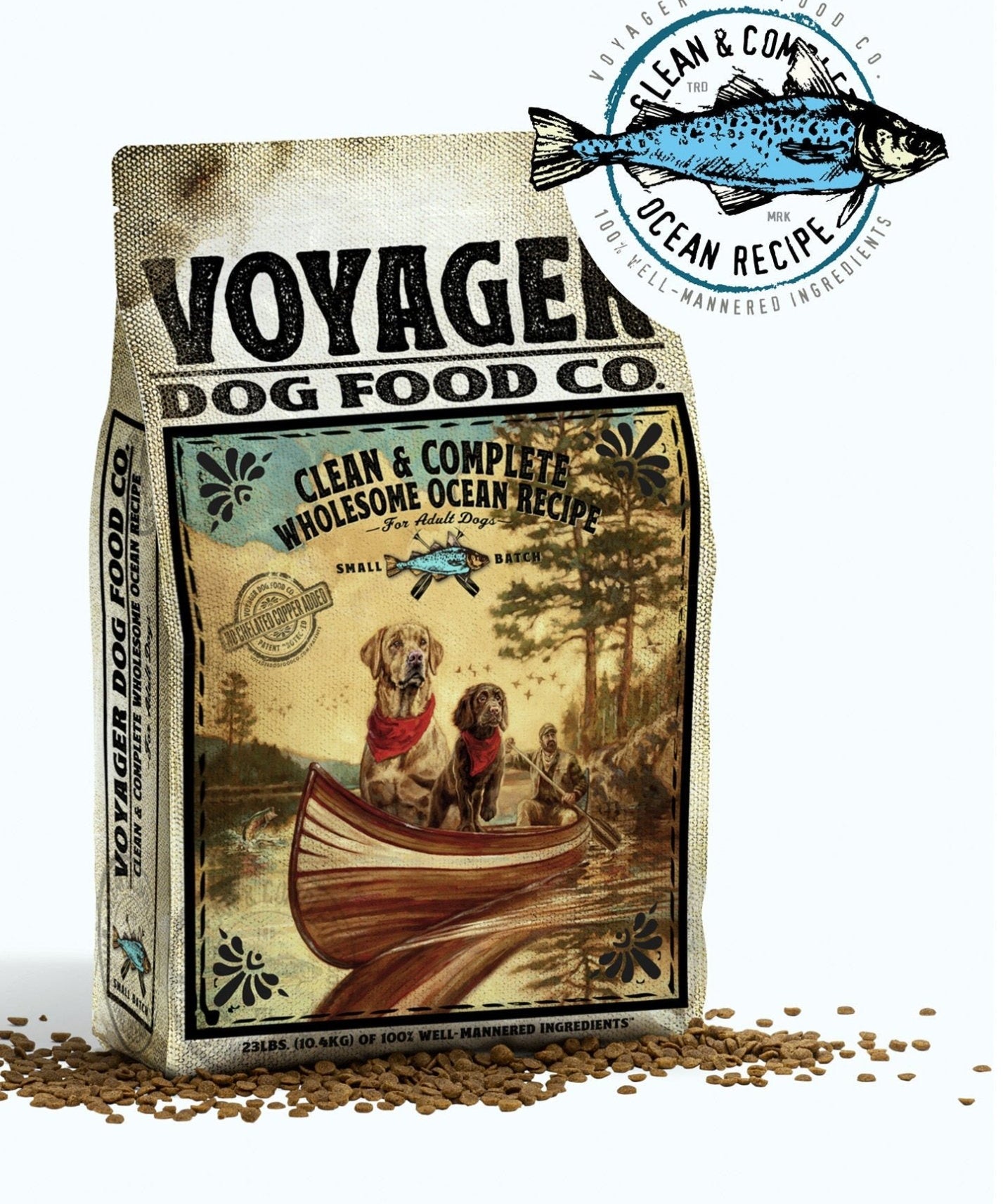 A bag of Voyager Dog Food Co. Dog Food with the label "Clean & Complete Wholesome Ocean Recipe," featuring two dogs in a canoe and scattered kibble around the package.