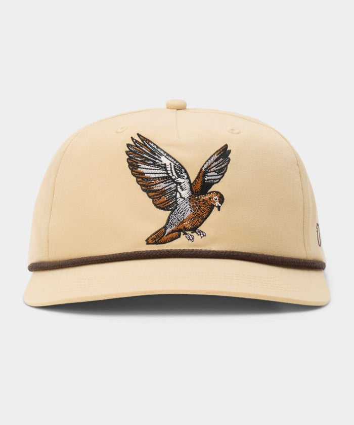 The Dove Hat by Duck Camp is a beige baseball cap with an embroidered bird in flight on the front and a brown trim above the brim—ideal for fans of dove poppers or bird snacks.