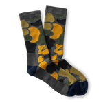 Duck Head Merino Wool Sock crew socks in a dark camo pattern with yellow accents and solid gray and navy blue heels and toes.