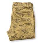 Folded tan Classic Fit Gold School Chino Wheatfield Print chinos featuring an all-over brown print of hunting dogs and ducks in tall grass.