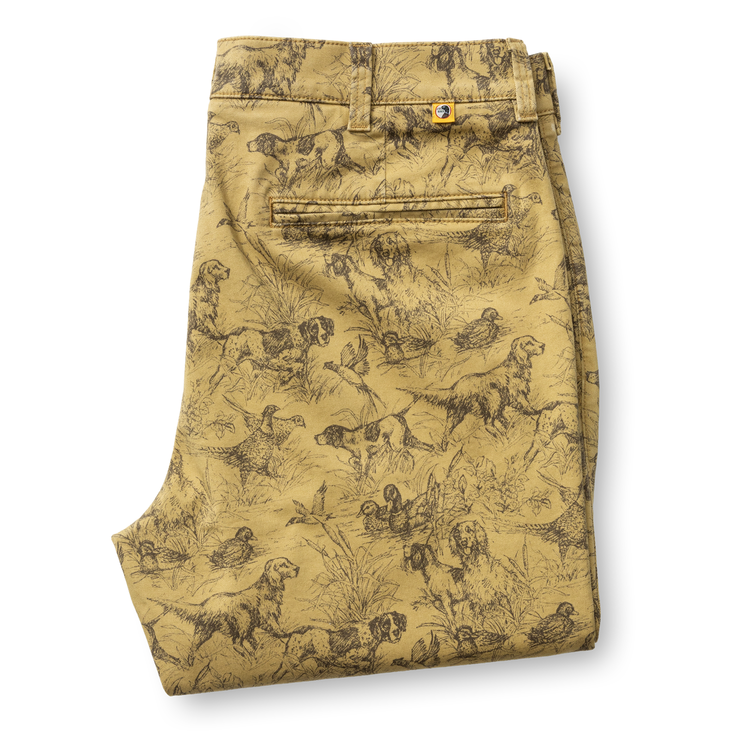 Folded tan Classic Fit Gold School Chino Wheatfield Print chinos featuring an all-over brown print of hunting dogs and ducks in tall grass.