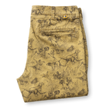 Folded tan Classic Fit Gold School Chino Wheatfield Print chinos featuring an all-over brown print of hunting dogs and ducks in tall grass.