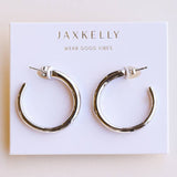 JaxKelly Everyday Silver Hoop Earrings by JaxKelly, featured on a white card with “Wear Good Vibes” printed above, are the perfect tarnish-free accessory for your daily style.