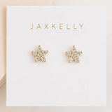 A pair of Pave Stud Flower earrings by JaxKelly, featuring sparkling white CZ gemstones set in a delicate floral design with durable gold plating. Displayed on a white card labeled “JaxKelly,” these hypoallergenic studs are ideal for sensitive ears.