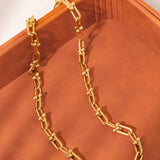 Denise Bold Chain Necklace by Flanerie by MAIQ, a hypoallergenic gold chain with rectangular links and spherical accents at the joints.