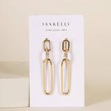 JaxKelly Pave Link Drop Earrings feature rectangular and oval gold links accented with white pavé stones. Displayed on a branded card reading "Wear Good Vibes." Hypoallergenic for comfortable wear; shown against a beige background.