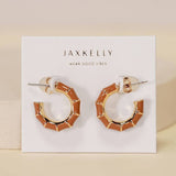 A pair of tarnish-free, hypoallergenic Vintage Hoop enamel and gold earrings by JaxKelly, displayed on a branded card.