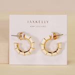 The JaxKelly Vintage Hoop Earrings are hypoallergenic, tarnish-free gold and enamel hoops displayed on a "Wear Good Vibes" card—perfect for sensitive ears and daily shine.