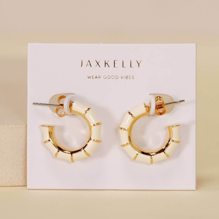 The JaxKelly Vintage Hoop Earrings are hypoallergenic, tarnish-free gold and enamel hoops displayed on a "Wear Good Vibes" card—perfect for sensitive ears and daily shine.