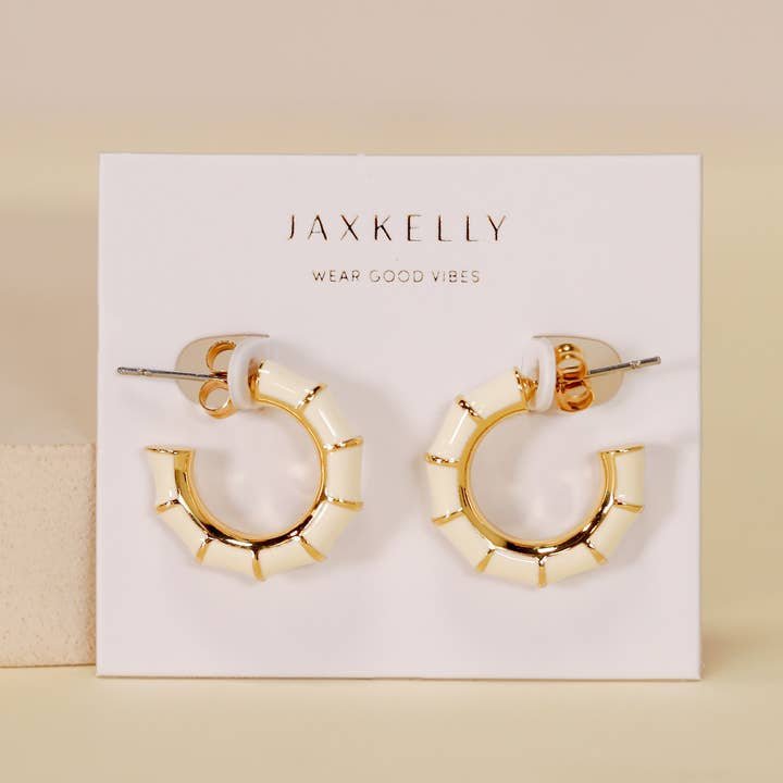 JaxKelly Vintage Hoop Earrings are hypoallergenic, tarnish-free, and ideal for sensitive ears. Displayed on a "Wear Good Vibes" card, these enamel gold hoops come from the JaxKelly brand and are shown against a neutral background.