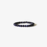The Earth Bracelet - Blue Sandstone by BRANCO features polished, dark blue round gemstones arranged in a circle and is shown on a plain white background.