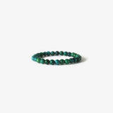 The Earth Bracelet - Chrysocolla by BRANCO features small round green and blue beads, including Chrysocolla gemstones, arranged in a simple circle and displayed on a white background.