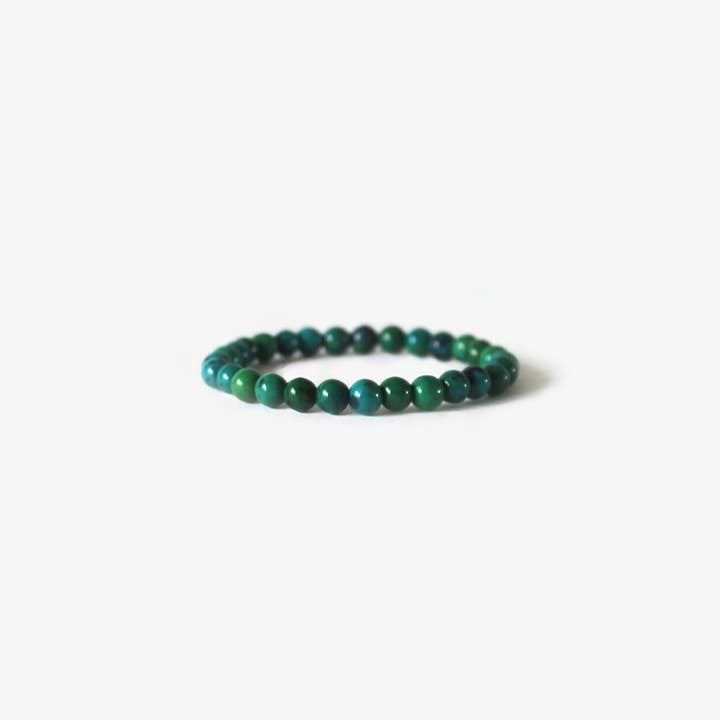 The Earth Bracelet - Chrysocolla by BRANCO features small round green and blue beads, including Chrysocolla gemstones, arranged in a simple circle and displayed on a white background.