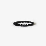 The Earth Bracelet - Matte Black Onyx by BRANCO is a simple beaded gemstone bracelet, displayed in a circular shape on a plain white background.