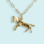 Wild Horses Necklace, a gold-tone necklace with a horse charm on a long-link cable chain.