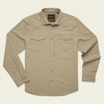 The Howler Brothers Emerger Tech Longsleeve is a light tan, lightweight shirt with UPF 35 protection, two chest pockets, snap buttons, and a collar—shown laid flat on a plain background.