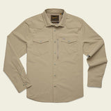 The Howler Brothers Emerger Tech Longsleeve is a light tan, lightweight shirt with UPF 35 protection, two chest pockets, snap buttons, and a collar—shown laid flat on a plain background.