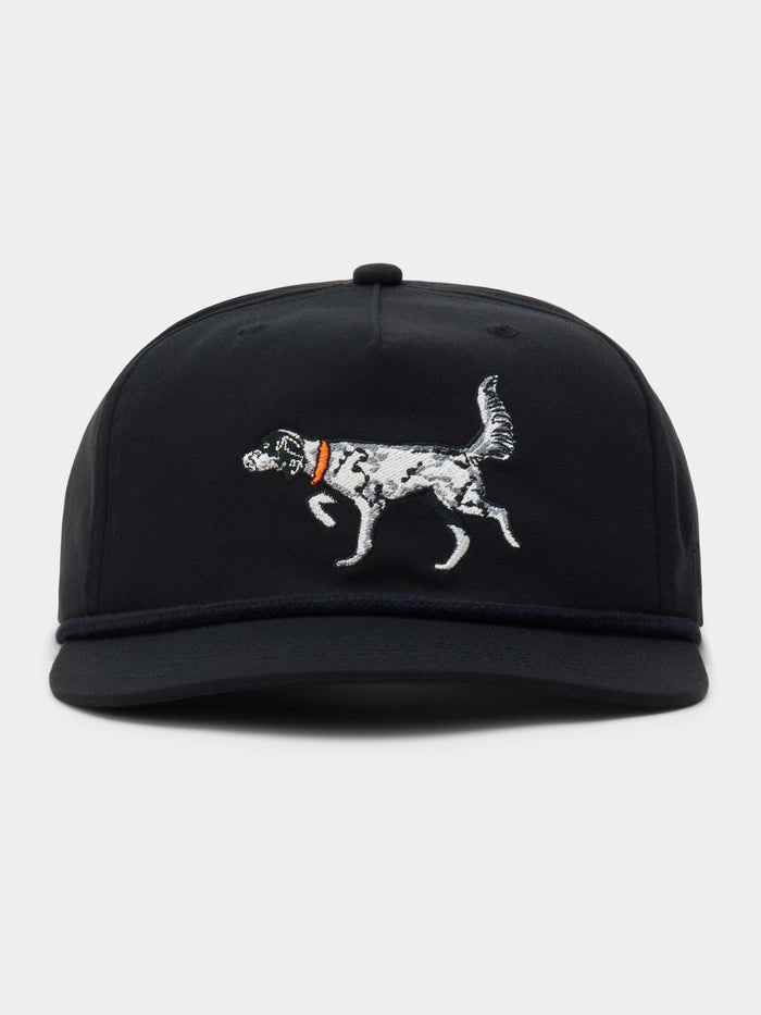 The Duck Camp English Setter Hat is a black adjustable cap with an embroidered dog in an orange collar on the front, made from a durable polyester shell.