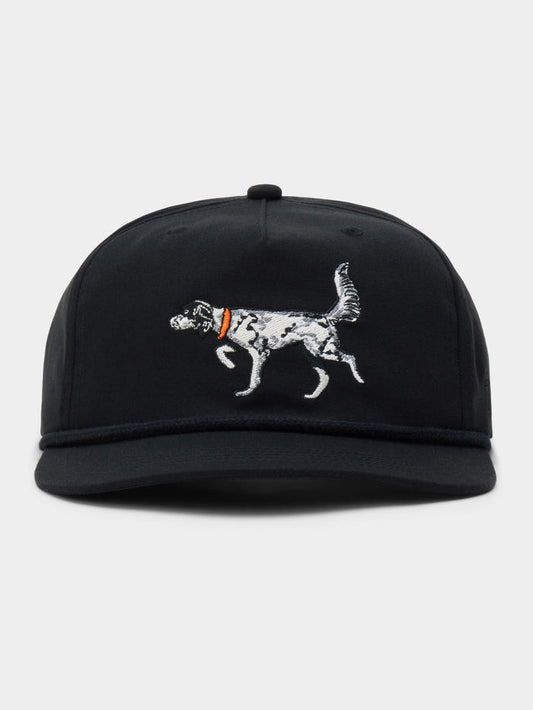 The English Setter Hat by Duck Camp is a black snapback cap with an embroidered white dog and orange collar on the front. Adjustable and made from durable polyester, it offers comfort and style for everyday wear.