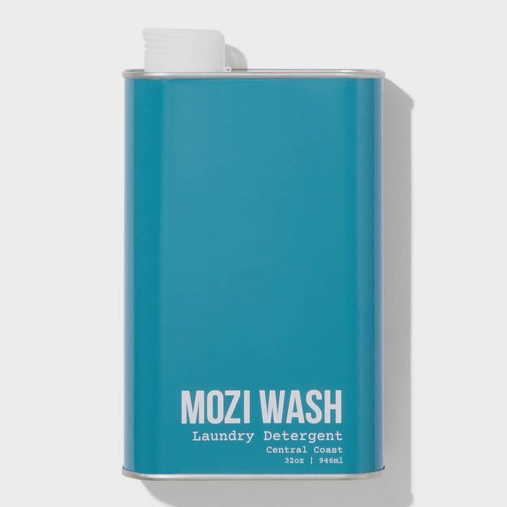 A teal rectangular metal container labeled “Central Coast Laundry Detergent | Mozi,” featuring a white spout on top and infused with a refreshing citrus scent for a clean, vibrant laundry experience.