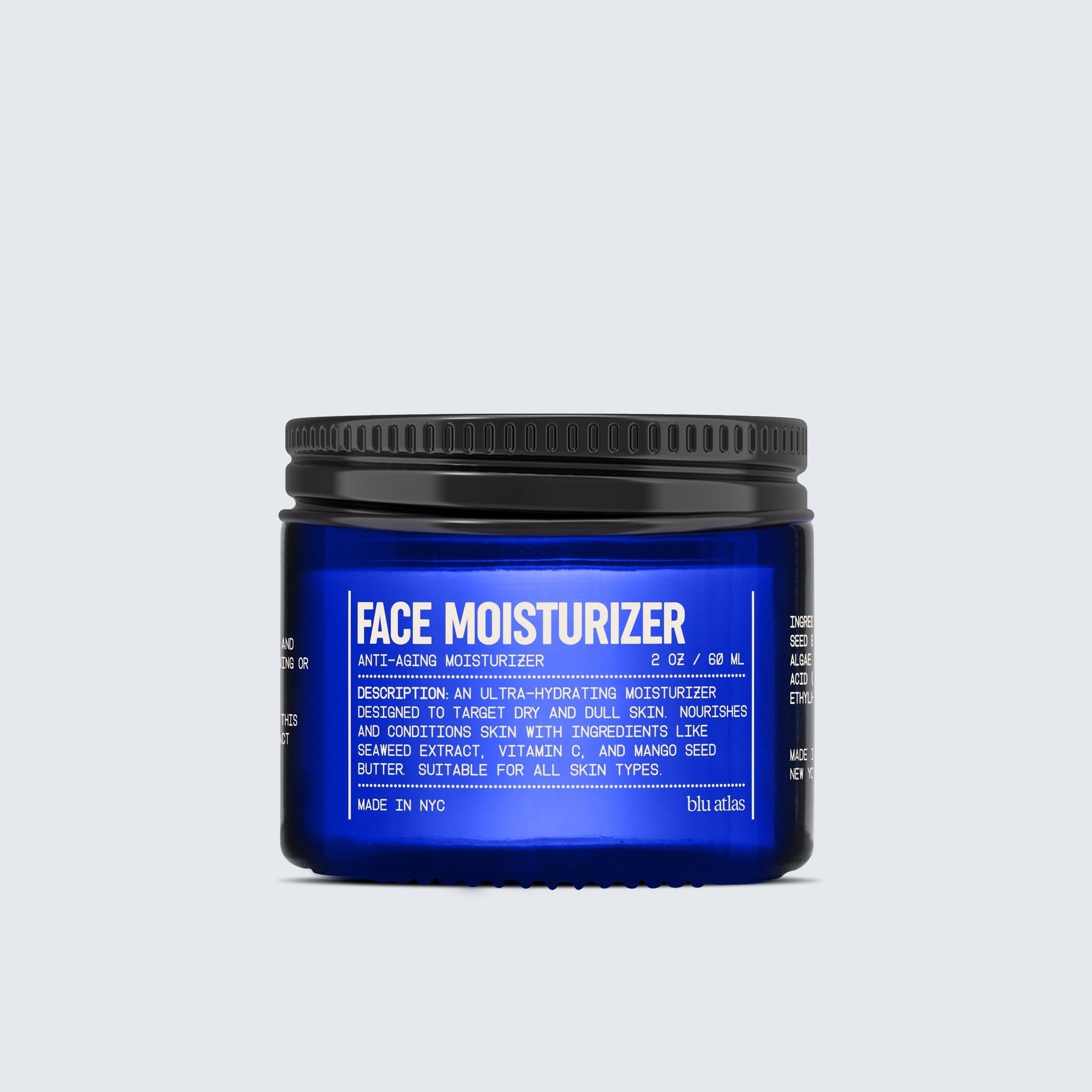 A blue jar of Blu Atlas Face Moisturizer with a black lid displays product details and ingredients, emphasizing its ultra-hydrating formula with seaweed extract for dry skin.