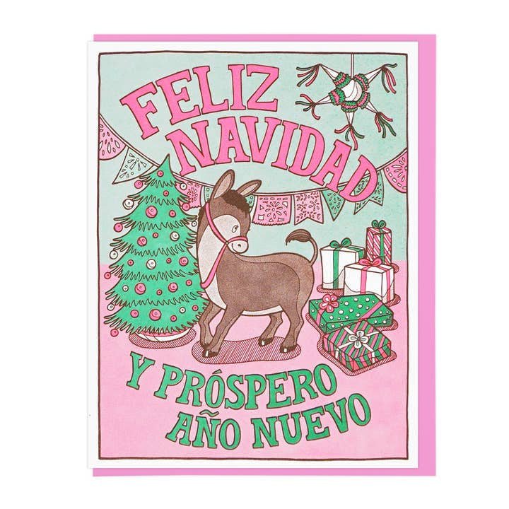 Lucky Horse Press "Feliz Navidad" card features a donkey, Christmas tree, gifts, and festive decor with "Feliz Navidad y Próspero Año Nuevo" in bold pink and green. Letterpress printed; blank inside for your message.