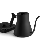 The Fellow Electric Kettle by Fellow, shown in matte black with a matching base and precision pour spout, is displayed on a white background.